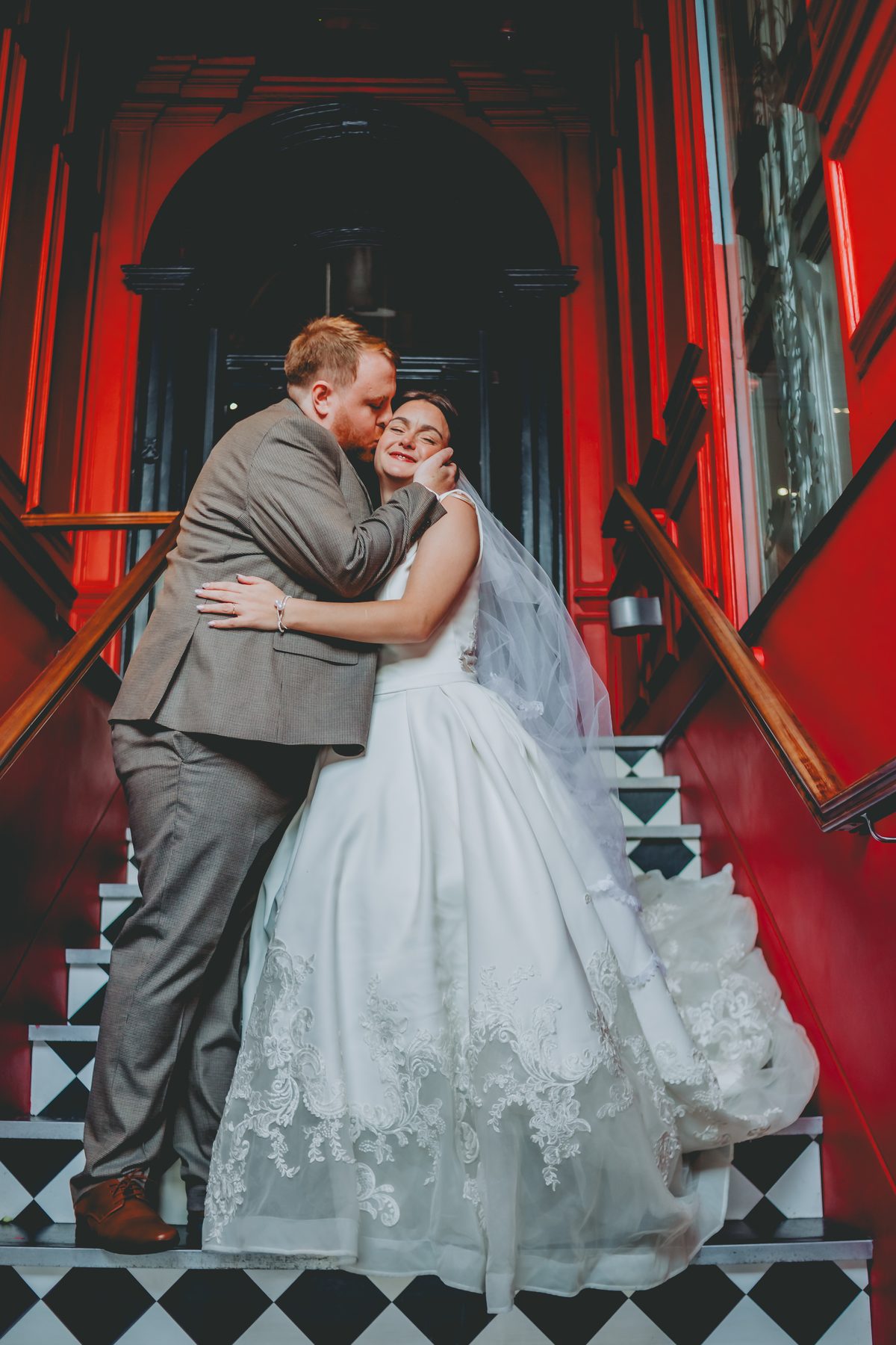 Bride and groom on the red staircase, Oddfellows Chester wedding photography